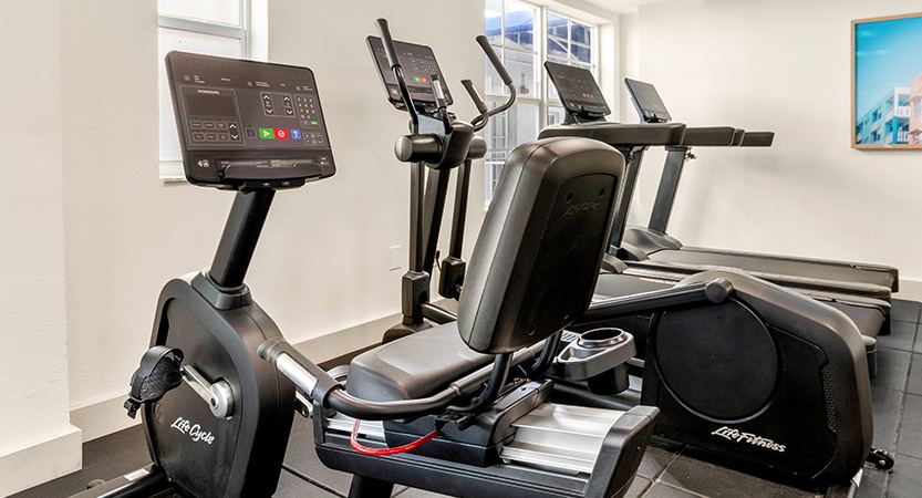 exercise bikes and a treadmill in the fitness center