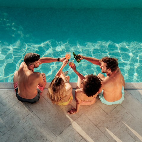 a group of people sitting by a pool