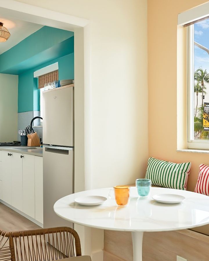 a small dining corner by the window with striped cushions